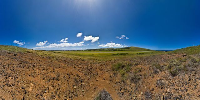 Since in the years 1970 NASA proceeded to the enlarging of the aerodrome of Mataveri, thus creating an emergency landing strip for the space shuttles, the large transport aircrafts can from now on land on this airport, more isolated from the world. This enlarging caused to increase the tourist frequentation of the island, which represents the first source of revenue today. The number of tourists remains however very limited compared to other tourist island. For reasons stated further below in this caption text, planes would approach and land exclusively from the northern end towards the southern end and lift off from the southern end towards the northern end.  Also, this is the only runway whatsoever within about 4000km. This means that airplanes bound for the island have to carry sufficient fuel for twice that distance - in case that landing on the island proves impossible for any reason and the aircraft has to proceed to the nearest available airport. This would be Tahiti or the Chilean coast. Pitcairn, the nearest inhabited land to the west, has no airstrip, and the nearest airstrip to the west at [...] is too short for long-range commercial airplanes.  The rest is Pacific Ocean.  As you can nearly see, the runway is not only short (3318m today from originally less than 3000m), but also, you better make best use of its length, or you end up not at elevation 10m above sea level, but at 2000m below it. It is a steep drop beyond the shore.  The Boeing 707 models operated by Lan Chile for the flight route from Santiago de Chile to Easter Island and then onwards to Papeete, Tahiti without fully refueling were custom-modified in order to extend their range so that they would be able to make the stretch.  Easter Island has no proper jet refueling facility. When plans were made by the Chilean government to build one, worldwide protests in favor of the preservation of the natural state of the island eventually led to the plans being abandoned.  So the 707s had a reduced passenger seating and cargo configuration and a supplemental full-height fuel tank installed in the aft section.so that they could land on Easter Island, lift off and continue on to Tahiti, where they would fully refuel for the first time after having left Santiago de Chile.  The modified 707 was back then the only long-distance passenger aircraft which could take that trip. That machine is still in service and is now operated by the Chilean army for civilian supplies and government cargo flights to the island.  A ship visited the island twice a year to bring regular supplies and fuel.  Also take note that the runway, now 3318m long after being extended by NASA in 1984 in order to accomodate an emergency Space Shuttle landing, was shorter in the 1970s. Check Wikipedia and you will see that the earlier 707 models had a landing and takeoff run longer than the actual length of the runway at IPC. In order to make up for that, they made use of a special topological feature of the runway:  The runway of Mataveri International Airport IPC is not horizontally level, but sloped by about five degrees. The 707s landing at IPC land uphill and take off downhill taking advantage of the gravitational acceleration and deceleration forces providing or reducing kinetic energy in order to make up for its insufficient length.  Starting pilots would take their 707s all the way to the southern end of the runway, turn the plane around almost on the spot, apply the brakes, turn their engines up to maximum emergency power, wait until the landing gear almost started to skid, and then let go off the brakes. Similarly, landing pilots would slow down their planes close to minimum control speed, below the minimum specified approach and landing speed, and close to the lower tolerance limit for the aircraft, hit the runway within its first meters fairly hard and applied maximum possible braking and reverse thrust power to get the aircraft to stop before it ran out of runway.